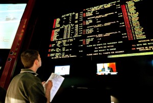 Steve Borys, an admin operator at Caesars Palace, checks the 2006 NCAA men's college basketball tournament bidding sheets to make sure the numbers match the board at the Caesars Palace sports book in Las Vegas, Monday, March 13, 2006.   (AP Photo/Jane Kalinowsky)