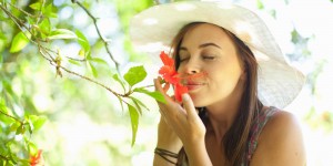 Woman smelling flower in park